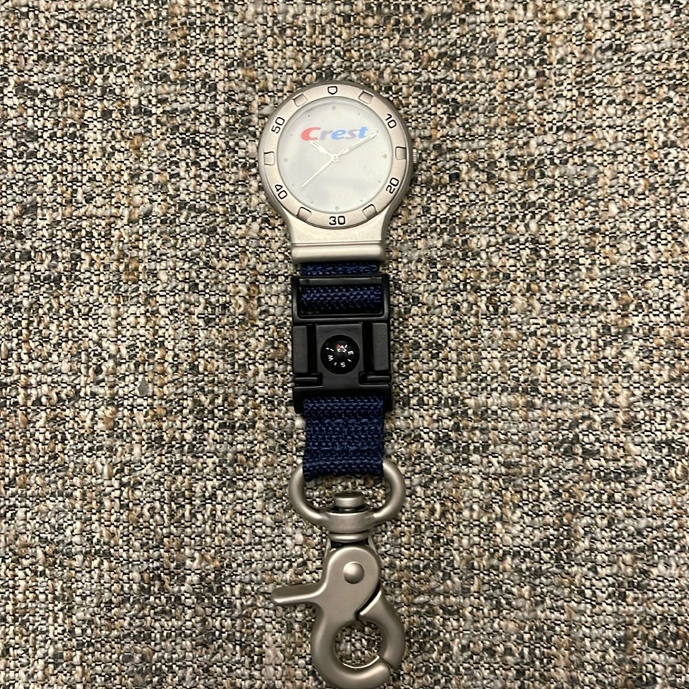 Crest toothpaste, watch with compass and a key ring
